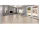 Living room with tile floors, gray walls, brick fireplace and double glass doors at 10115 W Turney Ave, Phoenix, AZ 85037