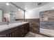 Bathroom boasts dual sinks, gorgeous marble-like tiling, and updated shower with pebble floor at 10410 W Royal Palm Rd --, Peoria, AZ 85345