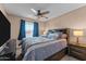 Bedroom featuring carpet, ceiling fan, queen bed and black furnishings at 10410 W Royal Palm Rd --, Peoria, AZ 85345