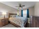 Bedroom featuring carpet, ceiling fan, queen bed and wood furnishings at 10410 W Royal Palm Rd --, Peoria, AZ 85345