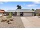 Single story home featuring desert landscaping, gray paint, brick accents, and a two car garage at 10410 W Royal Palm Rd --, Peoria, AZ 85345