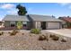 Single story home featuring desert landscaping, gray paint, brick accents, and a two car garage at 10410 W Royal Palm Rd --, Peoria, AZ 85345