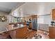 Open concept kitchen featuring a large island, stainless steel appliances, and wood floors at 10410 W Royal Palm Rd --, Peoria, AZ 85345
