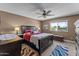 A traditionally furnished primary bedroom features a ceiling fan and a window view at 10410 W Royal Palm Rd --, Peoria, AZ 85345