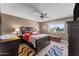 A traditionally furnished primary bedroom features a ceiling fan and a window view at 10410 W Royal Palm Rd --, Peoria, AZ 85345