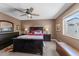 The dark wood furnishings accent this cozy primary bedroom and plush carpet at 10410 W Royal Palm Rd --, Peoria, AZ 85345