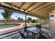Covered outdoor patio with outdoor seating and view of the pool, garden, and blue sky at 10410 W Royal Palm Rd --, Peoria, AZ 85345