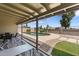 View of the pool and patio area with lush landscaping under a covered patio, perfect for outdoor relaxation at 10410 W Royal Palm Rd --, Peoria, AZ 85345