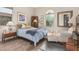 Inviting bedroom featuring wood-look floors, a cozy chair, and decorative accents at 10713 N 124Th Pl, Scottsdale, AZ 85259