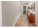 Traditional hallway with a wooden cabinet and view of the home's entry door at 10713 N 124Th Pl, Scottsdale, AZ 85259