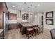 A spacious kitchen with dark wood cabinetry, a large island, and stainless steel appliances at 10713 N 124Th Pl, Scottsdale, AZ 85259