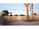 New wooden fence and palm trees enhance privacy in this backyard at 11014 W Cocopah St, Avondale, AZ 85323