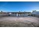 The backyard features a large dirt lot, patio cover and block wall at 11014 W Cocopah St, Avondale, AZ 85323