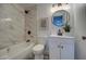 A modern bathroom with marble wall tile, soaking tub and vanity and decorative wall art at 11014 W Cocopah St, Avondale, AZ 85323