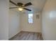 Bedroom with wood floors, ceiling fan, and bright window, offering comfort and natural light at 11014 W Cocopah St, Avondale, AZ 85323
