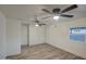 Bedroom with wood floors, white closet doors, and a ceiling fan for comfort at 11014 W Cocopah St, Avondale, AZ 85323