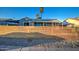Charming home with a new modern horizontal wood fence, bright blue door, and desert landscaping at 11014 W Cocopah St, Avondale, AZ 85323