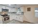 Updated kitchen showcasing white cabinets, modern hardware, and stylish backsplash at 11014 W Cocopah St, Avondale, AZ 85323