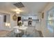 Eat-in kitchen with white cabinets, stainless steel appliances, and gray wood-look floors at 11014 W Cocopah St, Avondale, AZ 85323
