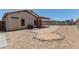 Image of the backyard, featuring rock ground cover, a covered patio, and well-maintained fencing at 1102 N 5Th St, Buckeye, AZ 85326