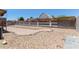 Spacious backyard featuring gravel, landscaping, and a tall block fence for added privacy at 1102 N 5Th St, Buckeye, AZ 85326