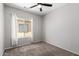 Bedroom with plush carpet, ceiling fan, and a view to the patio and backyard at 1102 N 5Th St, Buckeye, AZ 85326