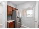 Kitchen area with stainless steel refrigerator, ample cabinet space, and a window for natural lighting at 1102 N 5Th St, Buckeye, AZ 85326