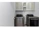 Laundry room with washer, dryer, and cabinets at 1102 N 5Th St, Buckeye, AZ 85326