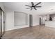 Well-lit living room featuring wood-look floors, access to the kitchen, and sliding doors to the outdoor space at 1102 N 5Th St, Buckeye, AZ 85326