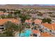 Aerial view showcasing community pool, surrounding buildings, and nearby shops and roads at 11375 E Sahuaro Dr # 2033, Scottsdale, AZ 85259