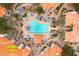 Aerial view of community pool with chairs, landscaping, and nearby homes at 11375 E Sahuaro Dr # 2033, Scottsdale, AZ 85259