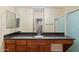 Bathroom featuring a large mirror, granite counters and custom cabinets at 11375 E Sahuaro Dr # 2033, Scottsdale, AZ 85259