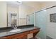 Bathroom featuring a granite counter, custom cabinets and walk-in shower at 11375 E Sahuaro Dr # 2033, Scottsdale, AZ 85259