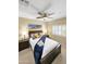 Bright bedroom with modern ceiling fan, mountain art, and luxurious king-size bed at 11375 E Sahuaro Dr # 2033, Scottsdale, AZ 85259