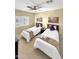 Bright bedroom featuring two twin beds, a ceiling fan and desert landscape art at 11375 E Sahuaro Dr # 2033, Scottsdale, AZ 85259