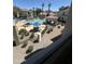 View of community pool with water feature, chairs, tables and shade, from a balcony at 11375 E Sahuaro Dr # 2033, Scottsdale, AZ 85259
