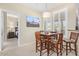 Charming dining area with wood table and chairs, and a large picturesque window with shutters at 11375 E Sahuaro Dr # 2033, Scottsdale, AZ 85259
