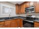 Spacious kitchen featuring stainless steel appliances, granite countertops, and wood cabinetry at 11375 E Sahuaro Dr # 2033, Scottsdale, AZ 85259