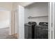Laundry room with black Samsung washer and dryer and open doorway at 11375 E Sahuaro Dr # 2033, Scottsdale, AZ 85259