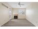 Living room with fireplace, neutral carpet, ceiling fan, and patio access at 11375 E Sahuaro Dr # 2033, Scottsdale, AZ 85259