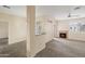 Inviting living room with a cozy fireplace, ceiling fan, and neutral colored carpet at 11375 E Sahuaro Dr # 2033, Scottsdale, AZ 85259