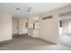 Open living room with neutral carpet, ceiling fan, and views to the kitchen at 11375 E Sahuaro Dr # 2033, Scottsdale, AZ 85259