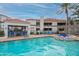 Resort-style pool area featuring blue lounge chairs, an outdoor kitchen, and well-maintained landscaping at 11375 E Sahuaro Dr # 2033, Scottsdale, AZ 85259
