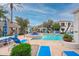 Sparkling community pool with comfortable lounge seating and shaded umbrellas for relaxing poolside at 11375 E Sahuaro Dr # 2033, Scottsdale, AZ 85259