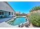 Private backyard features desert landscaping, pool with rock waterfall and covered patio at 11580 N 86Th Ln, Peoria, AZ 85345