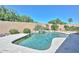 Backyard with desert landscaping, mature trees and a swimming pool with boulder features at 11580 N 86Th Ln, Peoria, AZ 85345