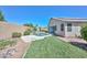 View of the backyard, pool, desert landscaping and enclosed block fence at 11580 N 86Th Ln, Peoria, AZ 85345