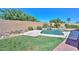Fully fenced backyard with manicured lawn, desert landscaping and a swimming pool at 11580 N 86Th Ln, Peoria, AZ 85345
