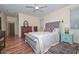 Comfortable bedroom with hardwood floors, dresser, and stylish decor for a relaxing retreat at 11580 N 86Th Ln, Peoria, AZ 85345