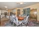 Open floor plan featuring a dining room adjacent to the kitchen with white cabinetry and stainless steel appliances at 11580 N 86Th Ln, Peoria, AZ 85345